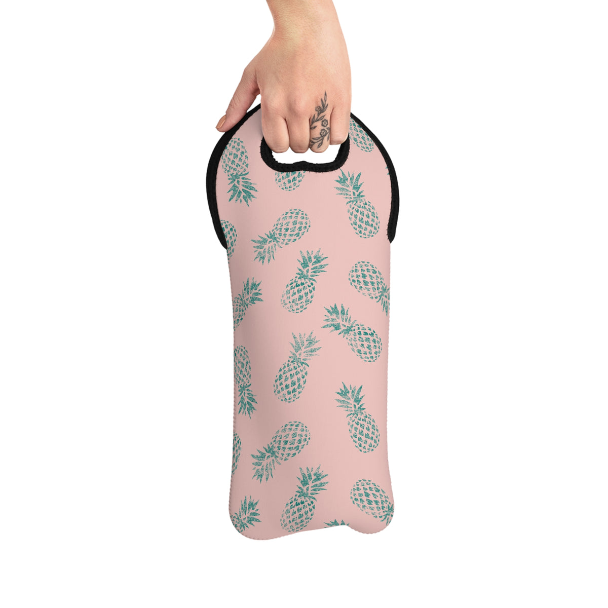 A pink neoprene wine tote featuring a repeating pattern of teal pineapples, with a black trim and a cutout handle at the top, shown on a plain white background.