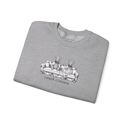 A gray-colored crewneck sweatshirt with a black and white graphic of a couch with pineapples and the text 'couch cruisers', folded with white background.
