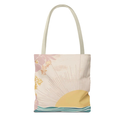 A canvas tote bag with a retro sunset illustration, featuring a cream-colored background with a yellow sun, pink clouds, and teal waves, complete with two cream shoulder straps.