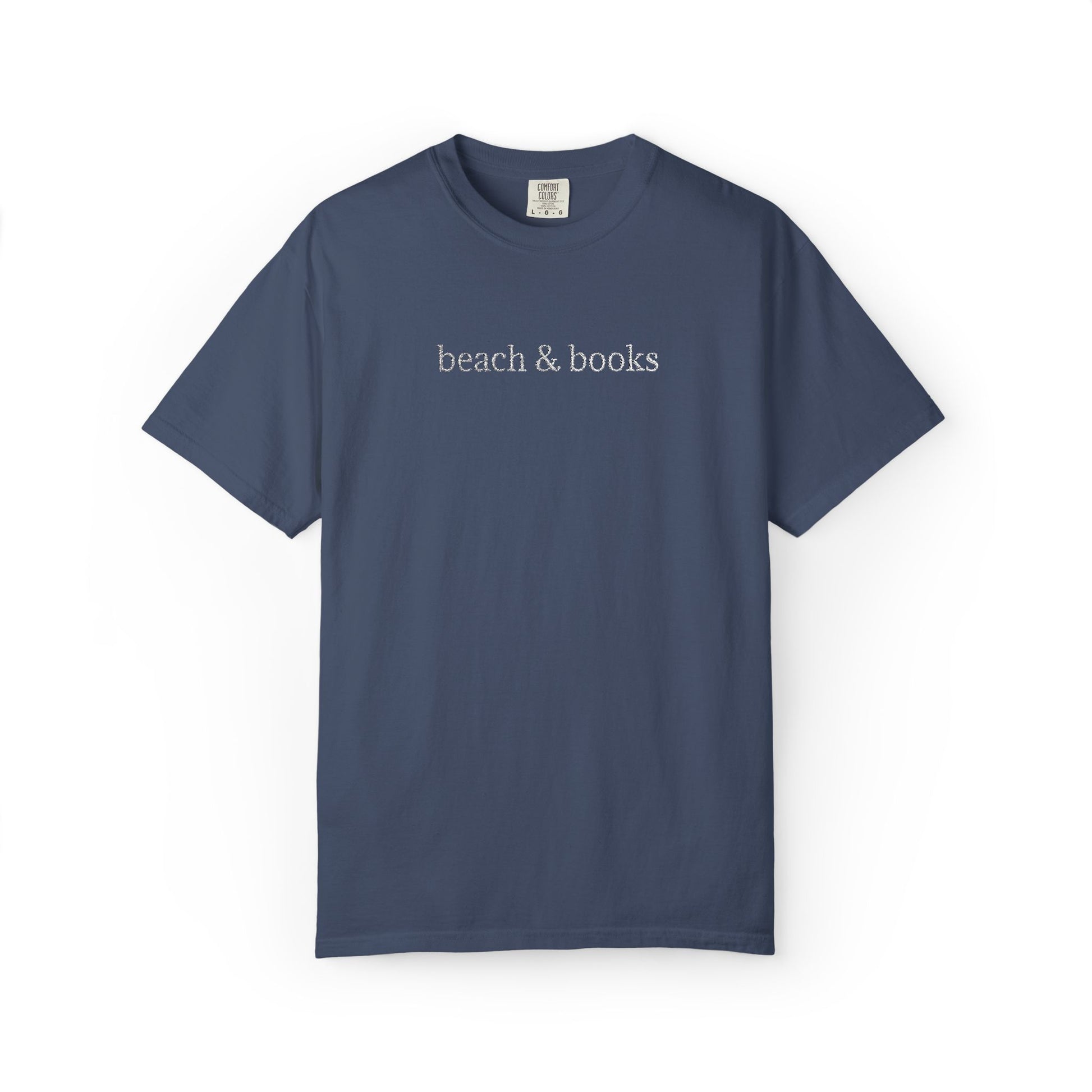 A blue comfort colors tee with 'beach & books' embroidered in white.