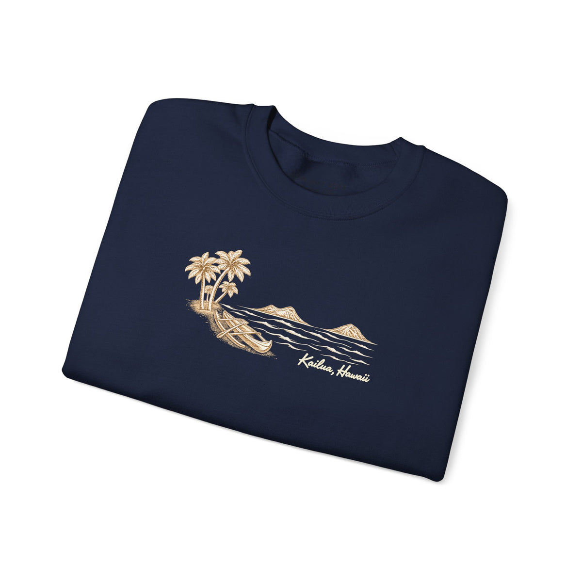 A folded navy blue crewneck t-shirt with a tan graphic of a tropical island, palm trees, a canoe, and the text 'Kailua, Hawaii' on the chest, displayed on a clean white background.