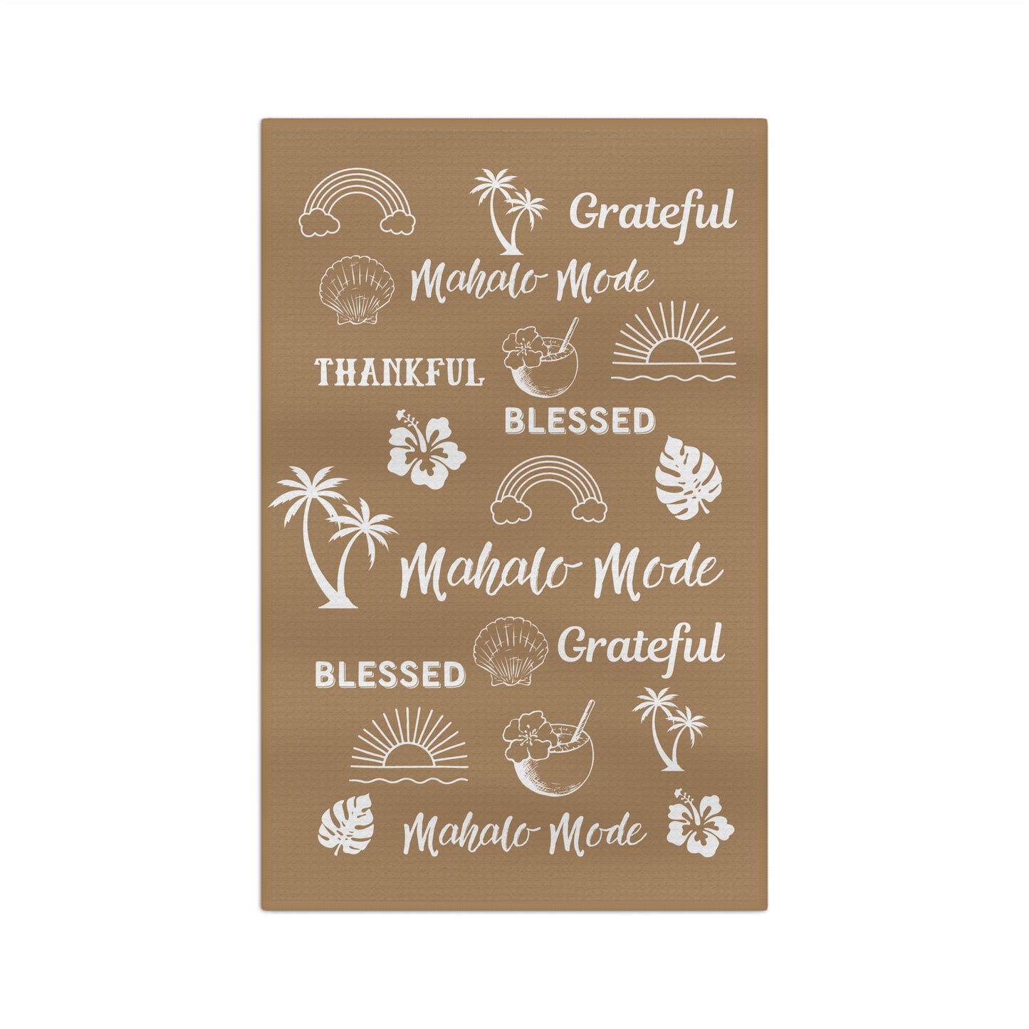 A tan kitchen towel with white tropical-themed illustrations and phrases including rainbows, palm trees, hibiscus flowers, seashells, and repeated text reading 'Grateful Mahalo Mode' and 'Blessed.'.