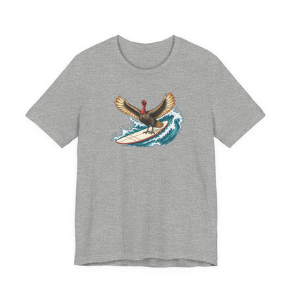 Athletic gray surfing turkey Thanksgiving T-shirt featuring a teal wave and vintage-inspired island artwork.