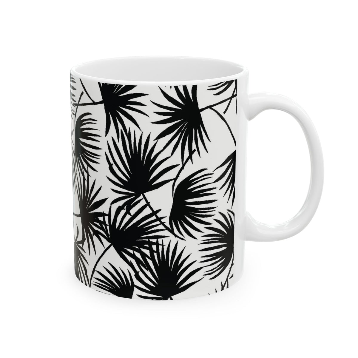 A white ceramic mug featuring a bold black palm leaf pattern, shown against a plain white background.