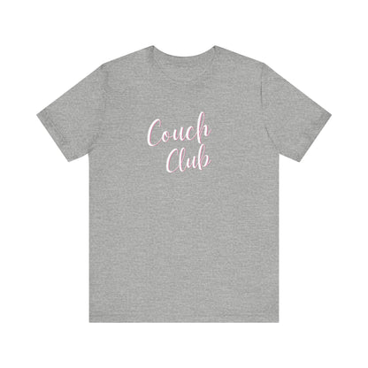 A heather gray crewneck t-shirt featuring the words 'Couch Club' printed in a pink cursive font across the chest, displayed on a solid white background.