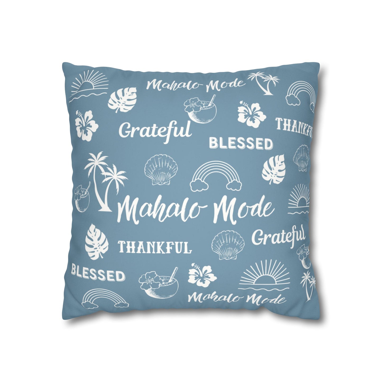 A square throw pillow in a dusty blue color, printed with white tropical-themed illustrations and words including 'Mahalo Mode', 'Grateful', 'Blessed', and 'Thankful'.