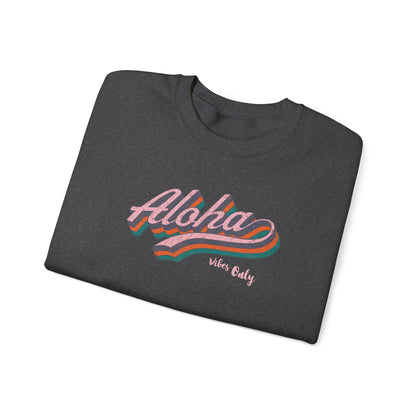 A folded dark heather gray t-shirt with a retro-style 'Aloha Vibe's Only' graphic in pink, orange, and teal, displayed on a clean white background.