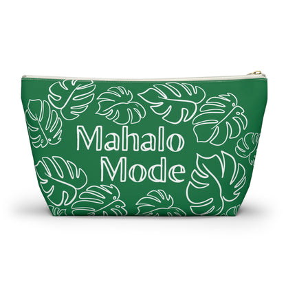 A green cosmetic pouch with a white monstera leaf pattern and the words 'Mahalo Mode' printed in white on the front, shown on a clean white background.