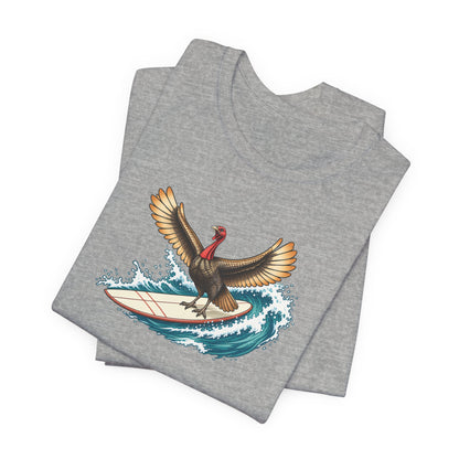 Athletic gray surfing turkey Thanksgiving T-shirt featuring a teal wave and vintage-inspired island artwork folded
