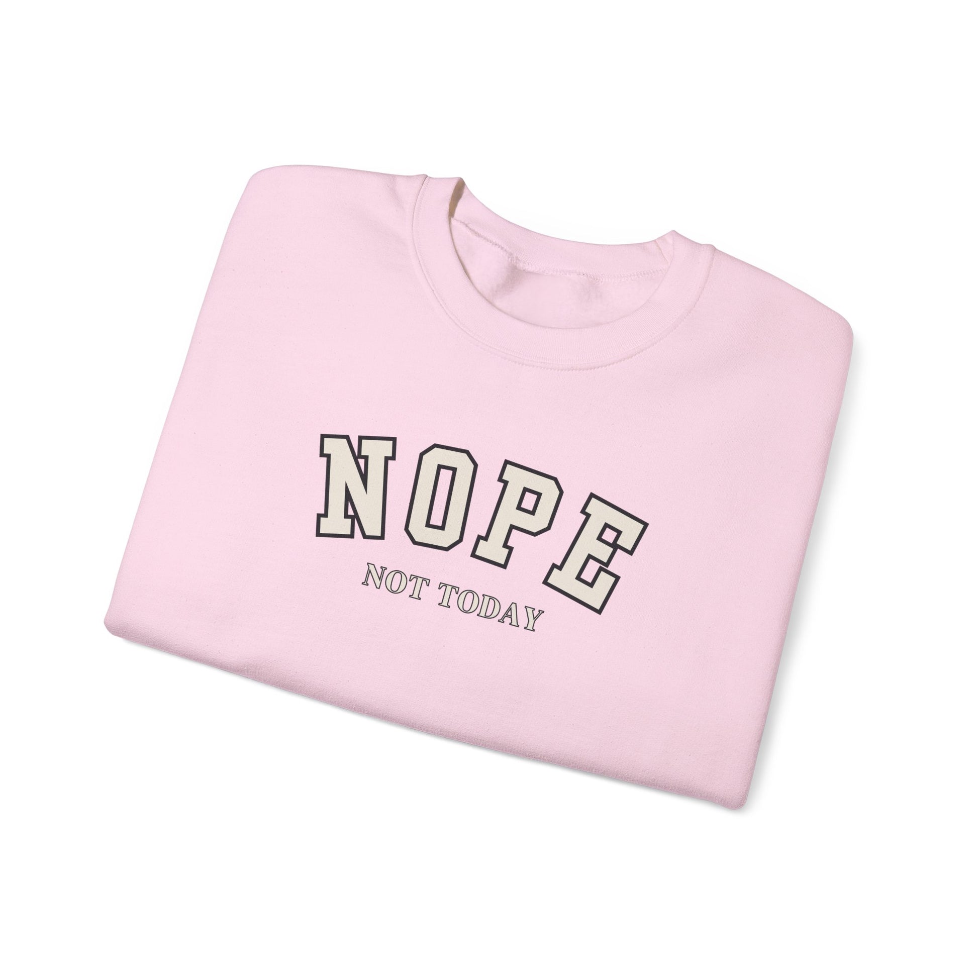 A folded light pink crewneck sweatshirt with the words 'NOPE NOT TODAY' printed on the front in a varsity-style font, shown on a clean white background.