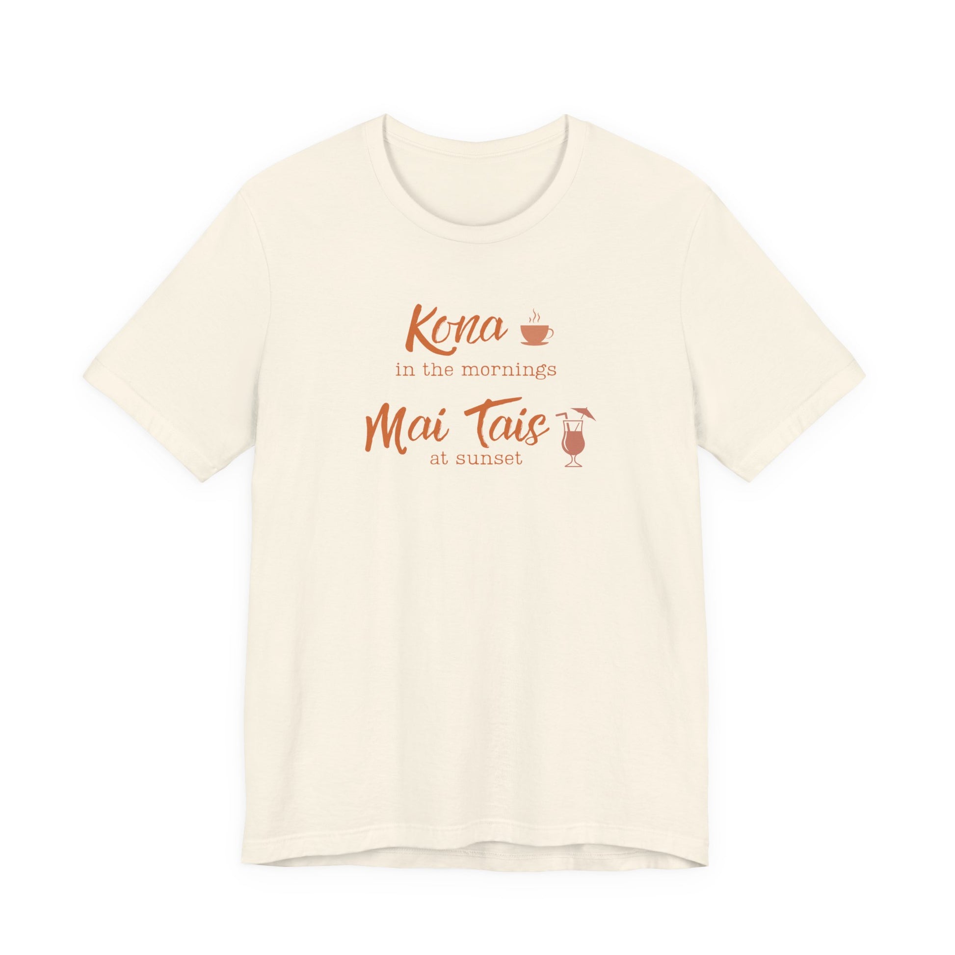 An off-white short-sleeve crewneck t-shirt with a coral orange graphic on the chest that reads 'Kona in the mornings Mai Tais at sunset' with small coffee and cocktail illustrations.