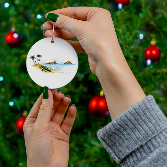 White ceramic ornament featuring a Kaʻōhao Kailua coastal sketch with canoes, palm trees and the Mokulua islands.