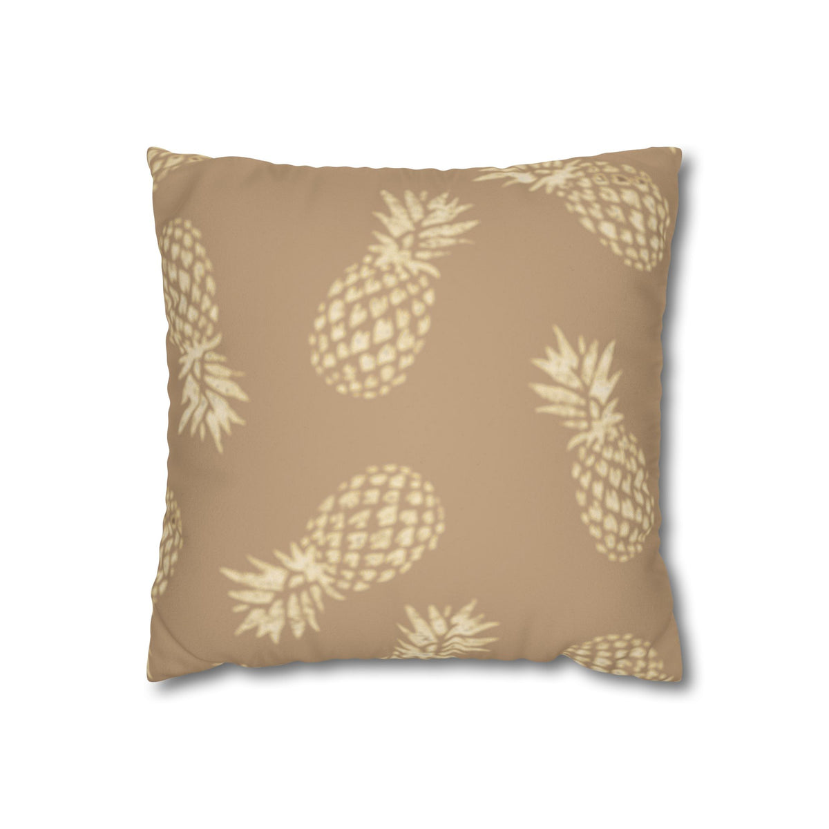 A square throw pillow featuring a repeating pattern of light beige pineapples on a warm tan background, shown against a plain white studio background.