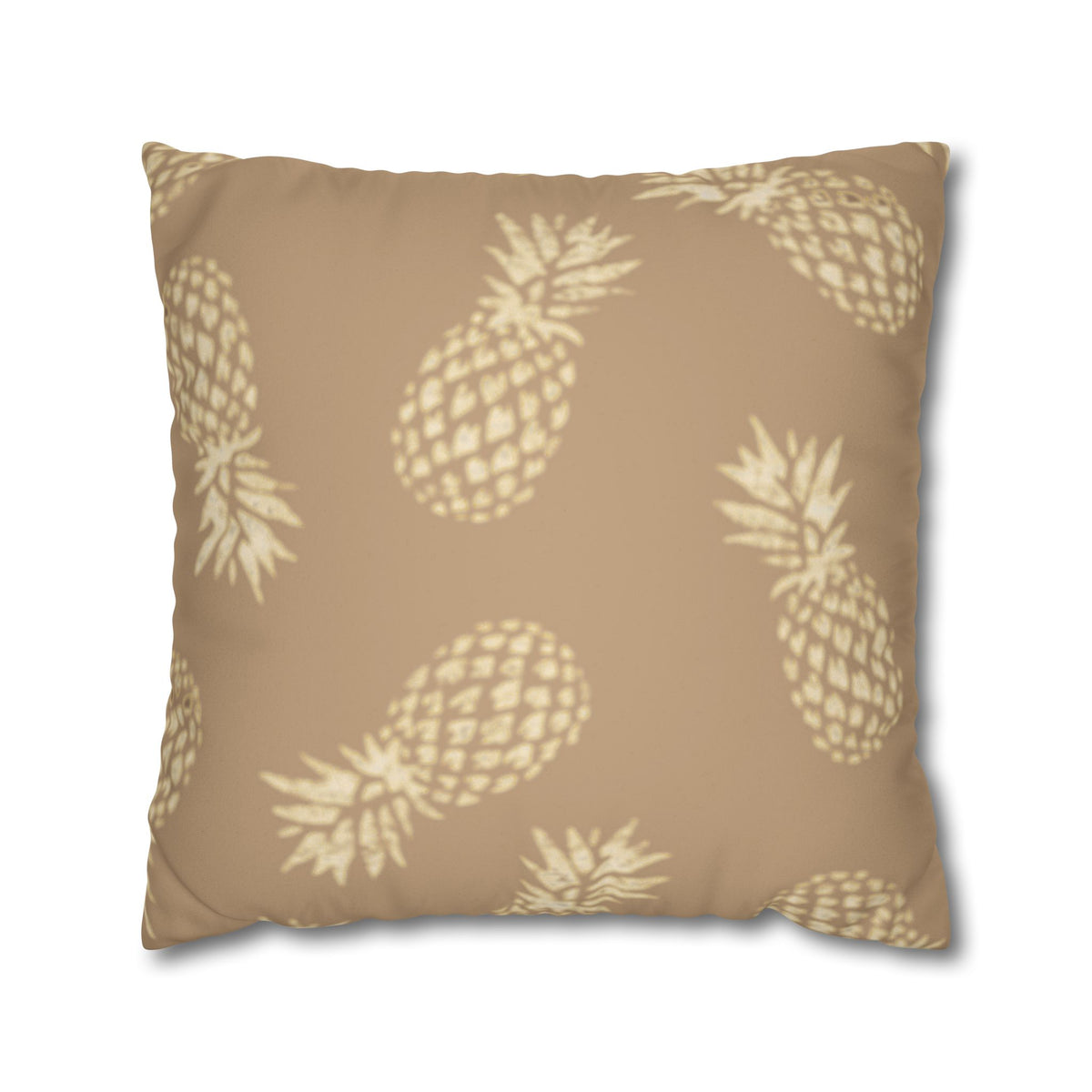 A square throw pillow in a warm tan color with a repeating cream pineapple pattern, shown against a plain white background.