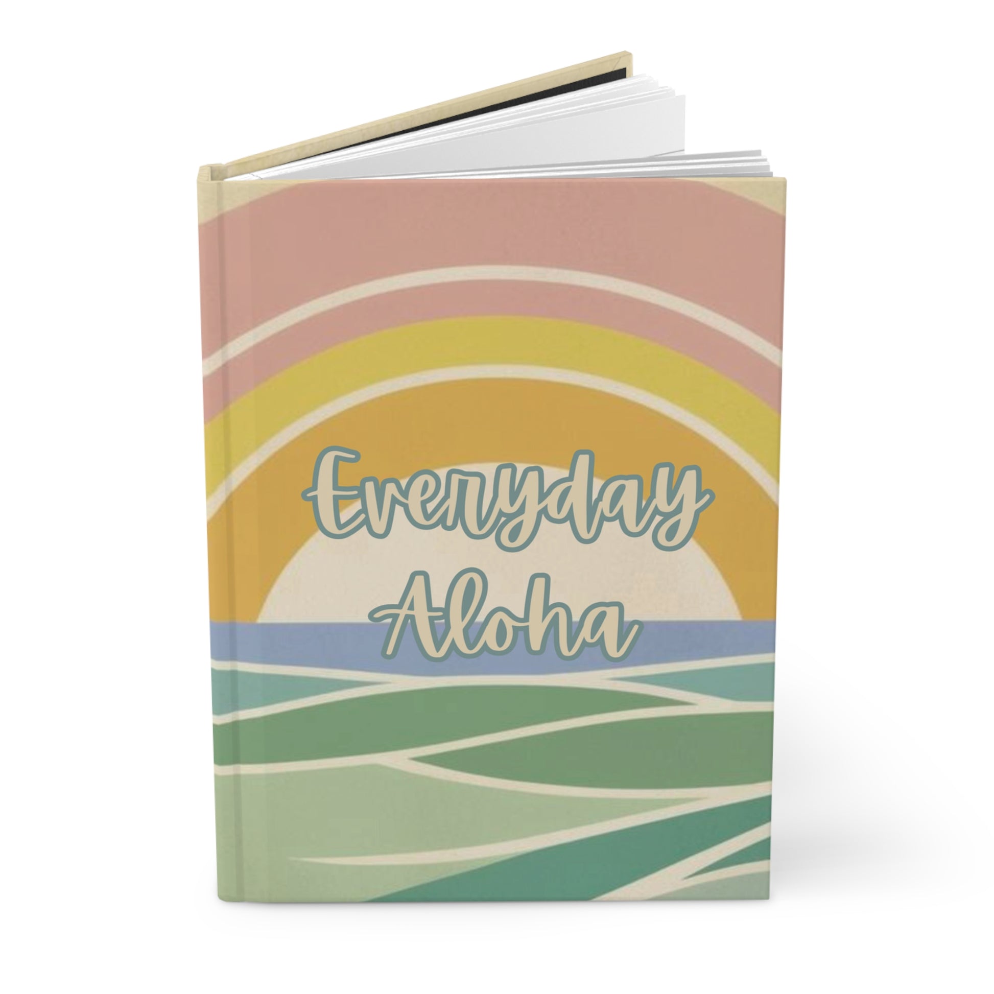 A hardcover notebook with a retro sunset and ocean design on the cover, featuring the text 'Everyday Aloha' in a light blue script. The cover has pastel colors including pink, yellow, blue, and green, and is shown standing upright on a white background.