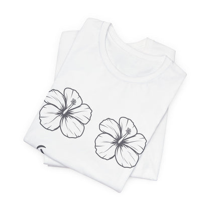 A folded white short-sleeve t-shirt with two black line-art hibiscus flowers printed on the front, displayed on a clean white background.