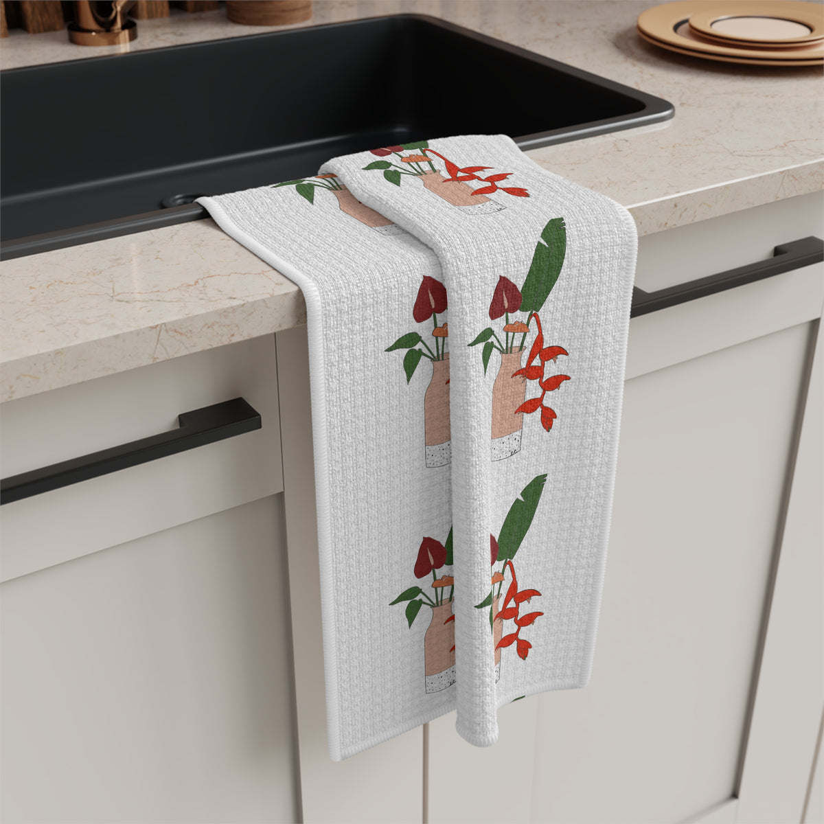 Anthurium Bouquet Hawaiʻi kitchen towel with red anthuriums and tropical green leaves on a neutral background draping off a kitchen sink