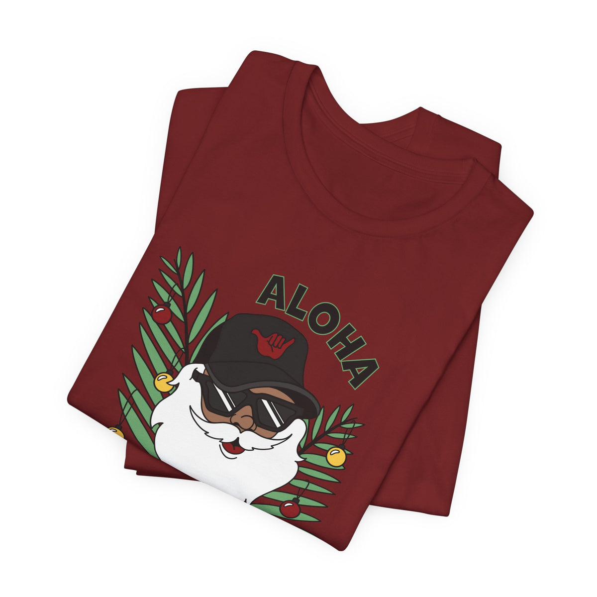 Folded Cardinal Red Santa Kalikimaka unisex T-shirt with hand-drawn Santa wearing sunglasses and throwing a shaka surrounded by tropical palm leaves.