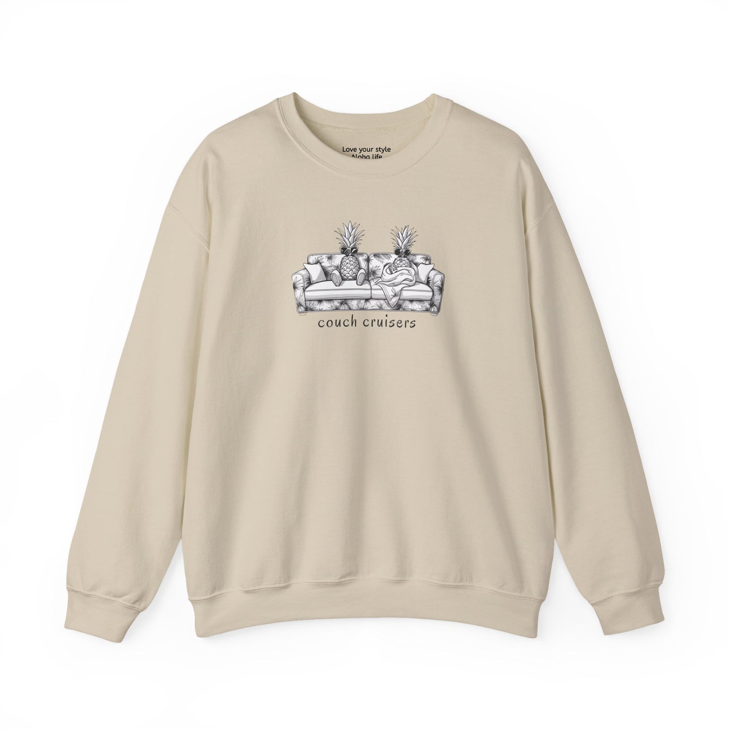 A beige crewneck sweatshirt featuring a black and white line art graphic of a couch with pineapples and the text 'couch cruisers' on the chest, displayed against a solid white background.