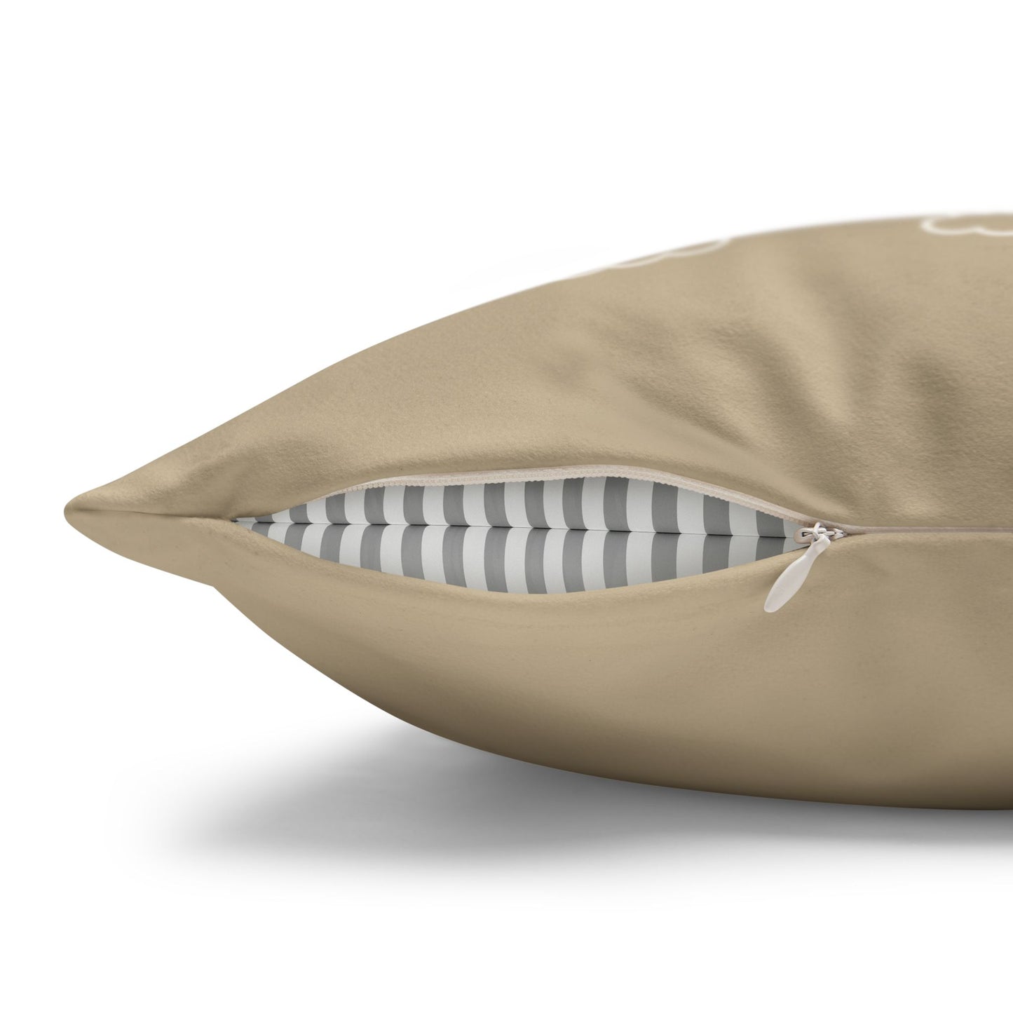 A close-up of a beige throw pillow with a zipper opening, showing a gray and white striped inner lining, on a white background.