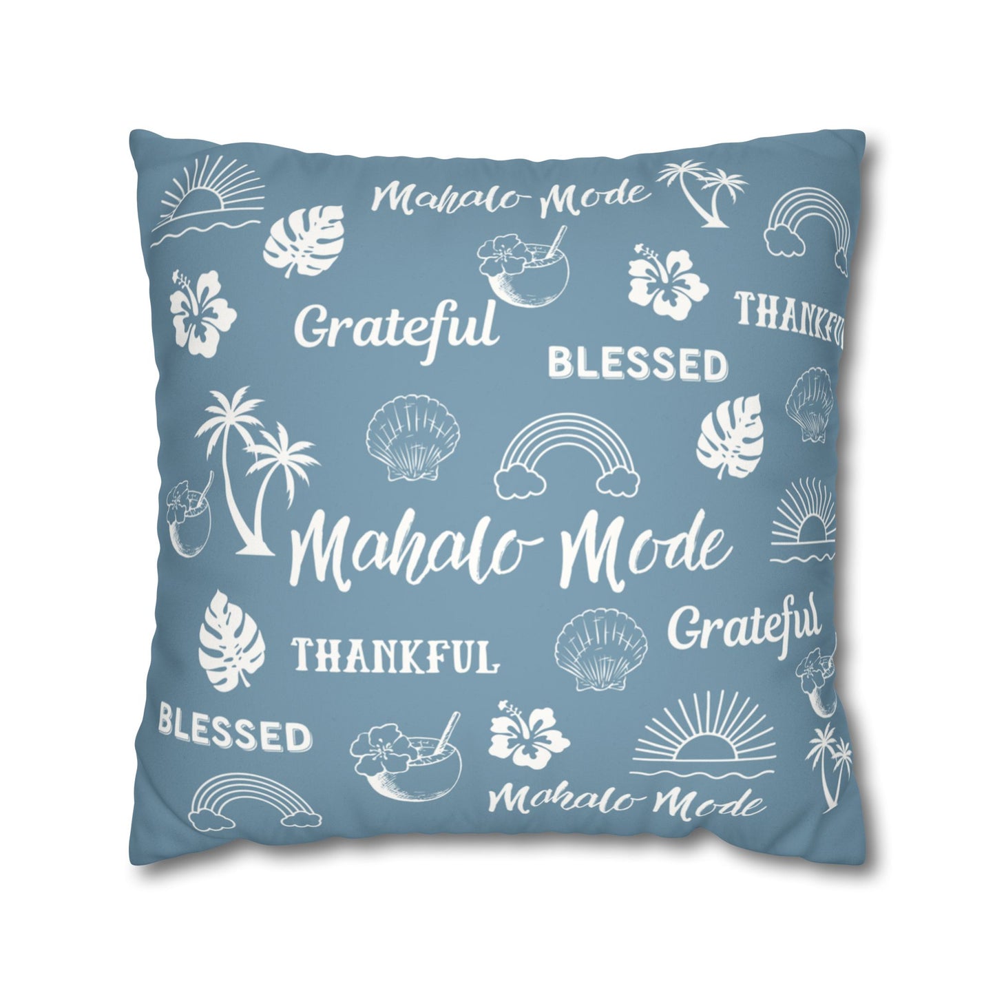 A square throw pillow in a dusty slate blue color, printed with white tropical-themed illustrations and words including 'Mahalo Mode', 'Grateful', 'Blessed', and 'Thankful'.
