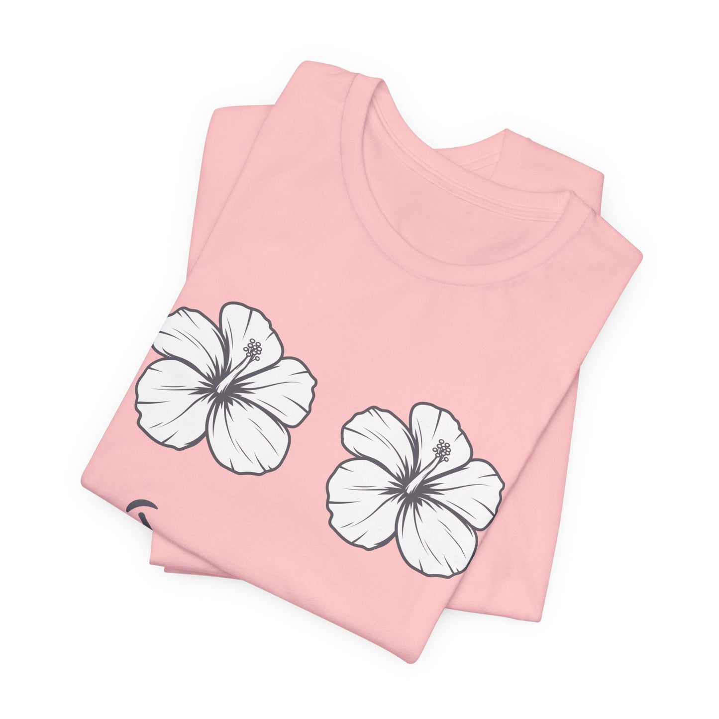 A folded light pink t-shirt with two white hibiscus flower graphics outlined in black, displayed on a clean white background.