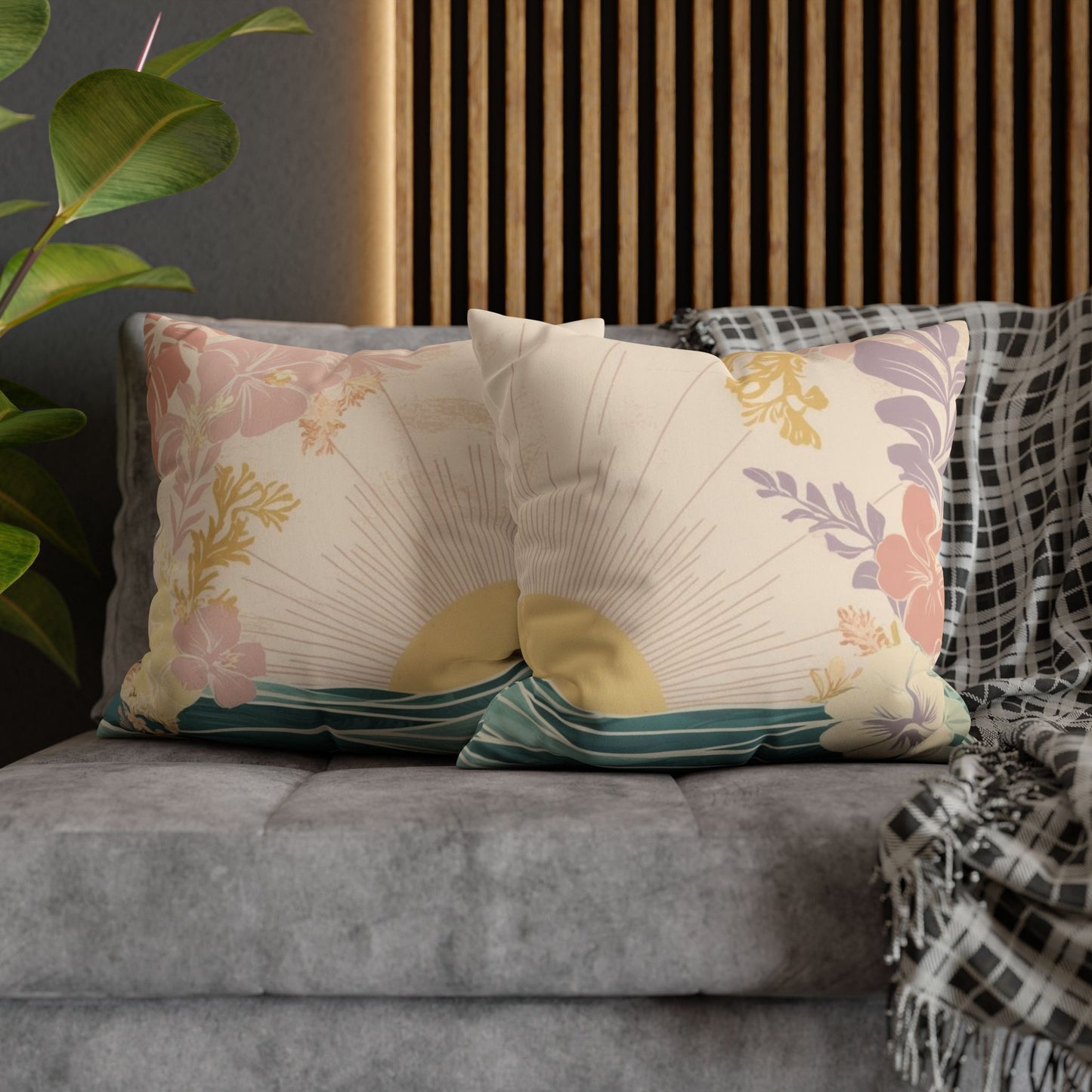 2 pastel sunrise wave faux suede pillows, featuring tropical florals and ocean-inspired artwork sitting on a couch in a living room