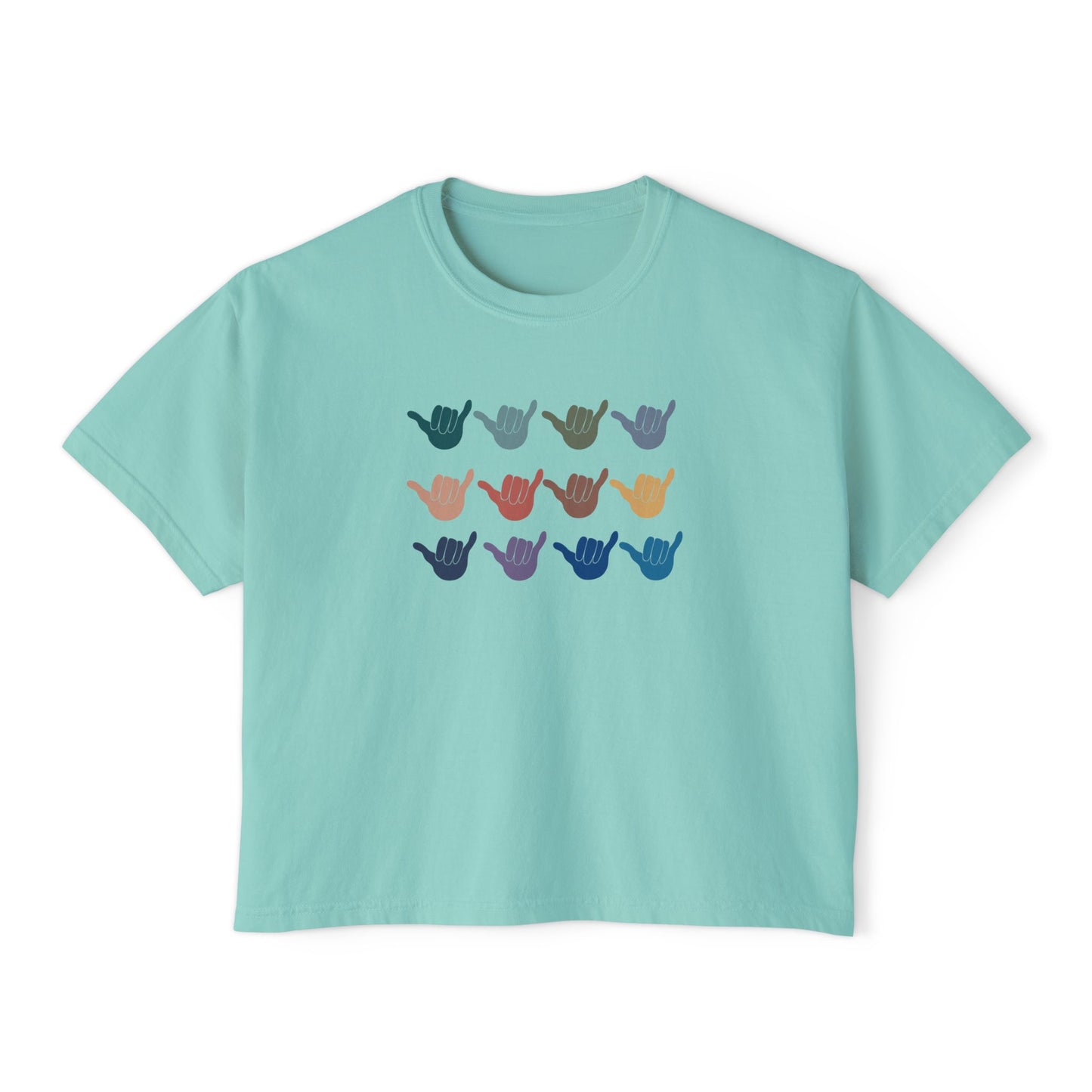 A light teal crop short-sleeve t-shirt with a graphic of twelve shaka signs in various colors arranged in three rows, displayed on a clean white background.
