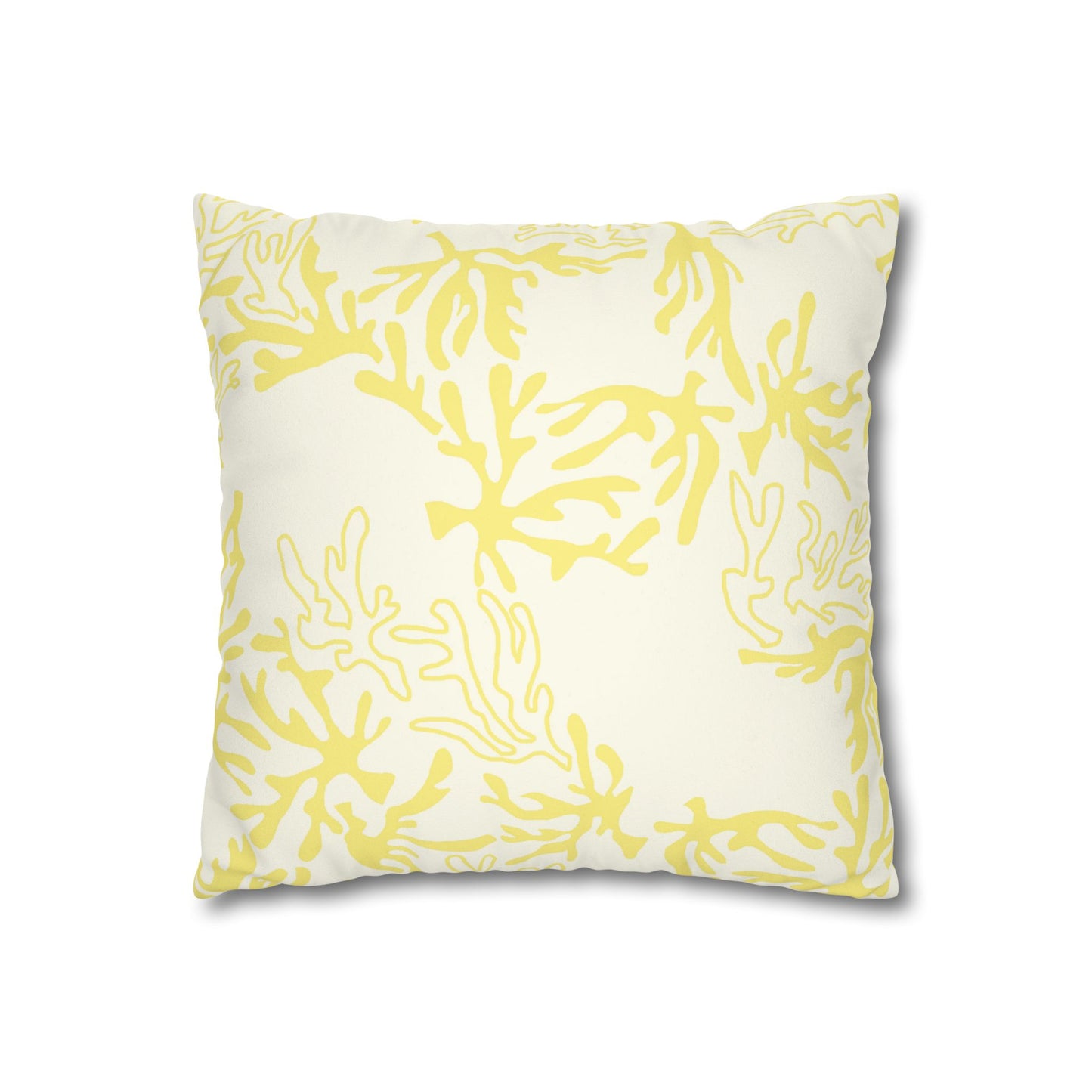 A square throw pillow featuring a yellow coral or seaweed-like abstract pattern on an off-white background, shown against a plain white studio backdrop.