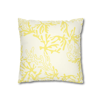 A square throw pillow featuring a yellow coral or seaweed-like abstract pattern on an off-white background, shown against a plain white studio backdrop.