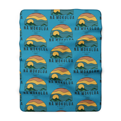Nā Mokulua Kailua Hawaiʻi sherpa fleece blanket with colorful island print and plush cream backing