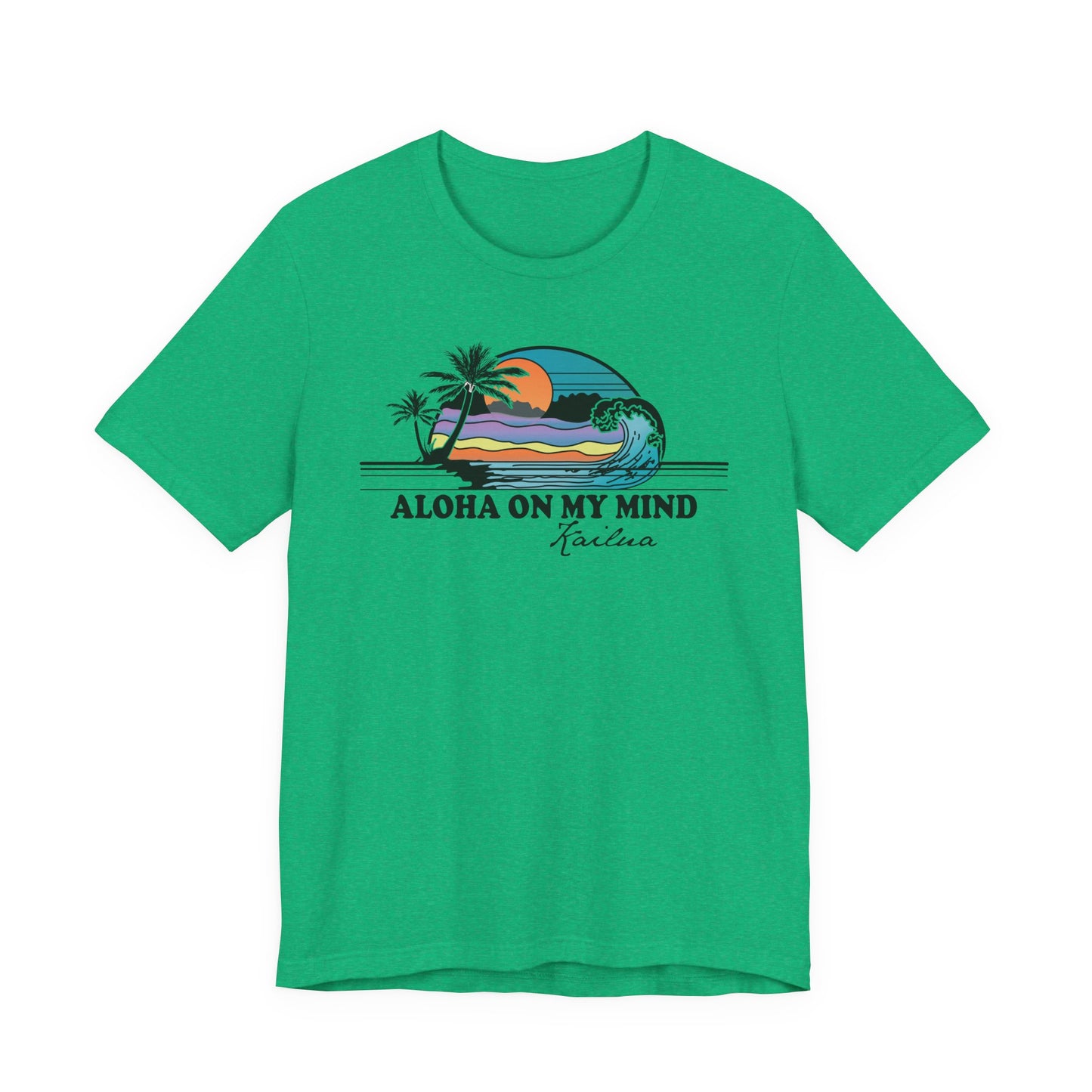 A green short-sleeve crewneck t-shirt featuring a retro graphic of a beach sunset with palm trees and the text 'ALOHA ON MY MIND' and 'Kailua' printed on the chest.