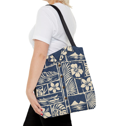 A woman wearing a white t-shirt and black pants carries a navy blue and cream Hawaiian-themed canvas tote bag with a black shoulder strap.