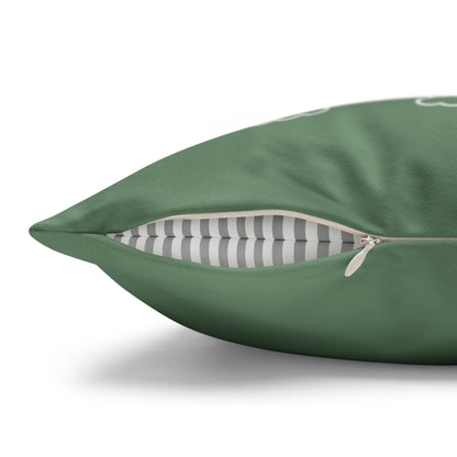 A close-up of a green throw pillow with a partially unzipped front, revealing a gray and white striped interior lining, on a white background.