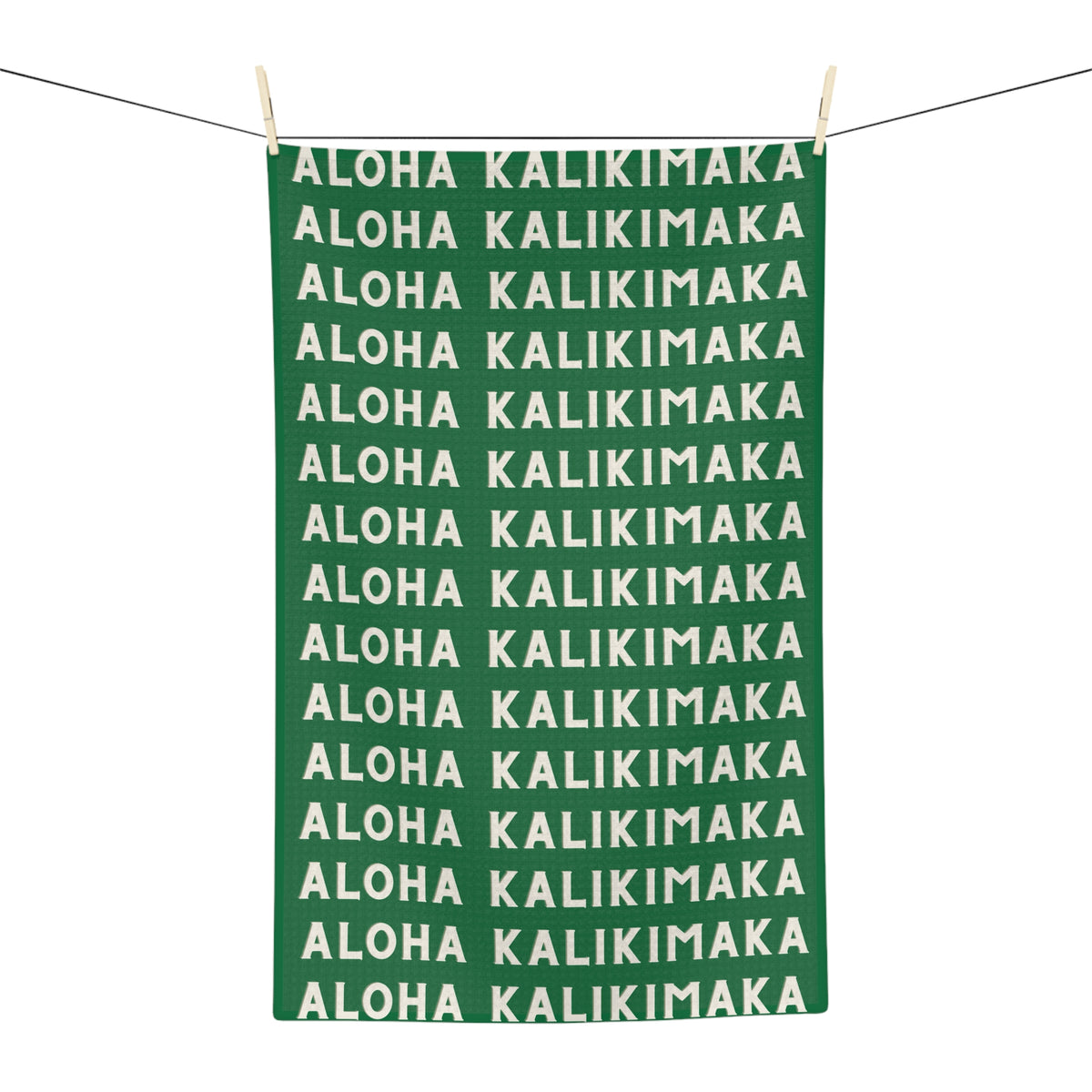 Green Aloha Kalikimaka holiday kitchen towel with repeating cream lettering