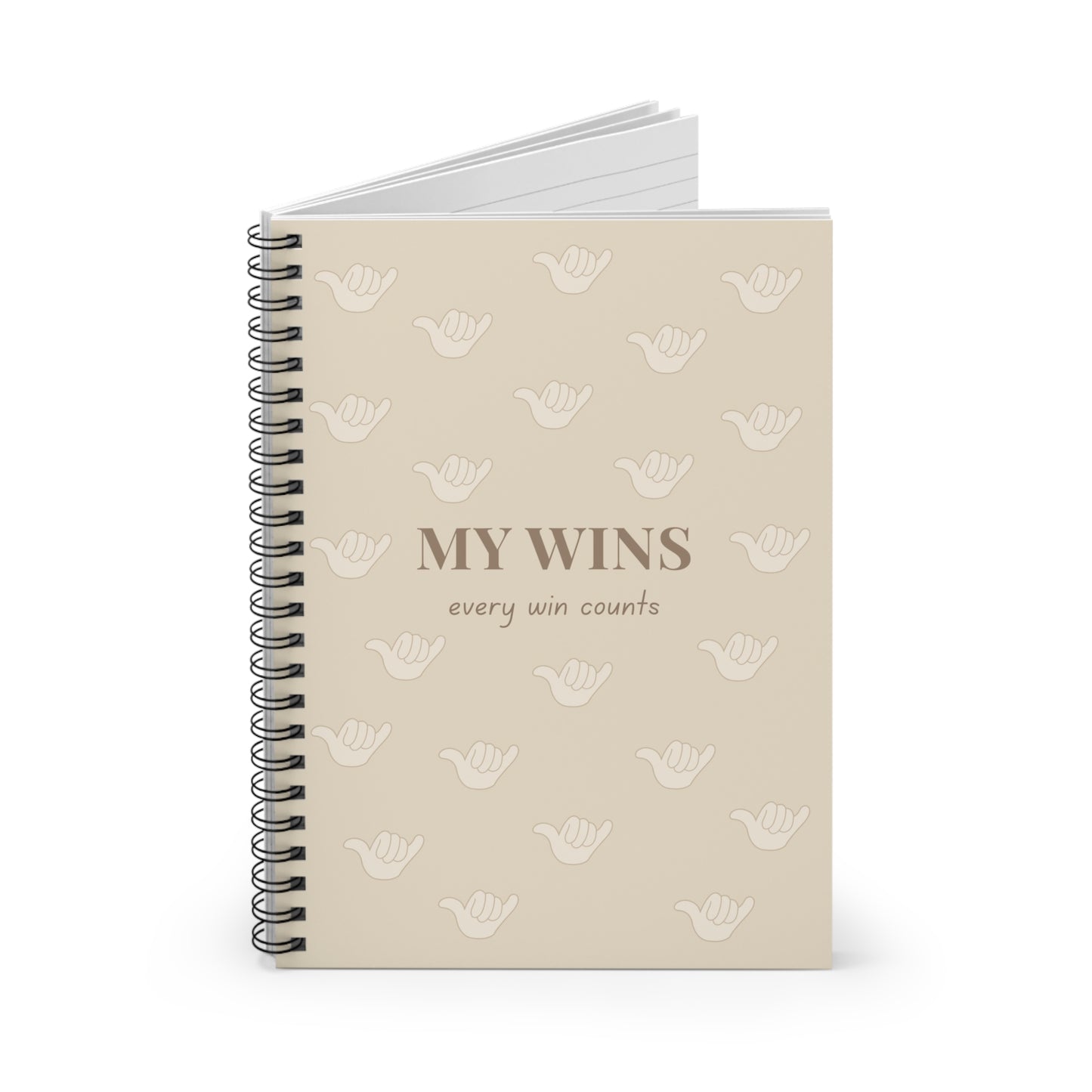 A beige spiral-bound notebook with a black wire binding, featuring the text 'MY WINS every win counts' and a repeating pattern of white shaka icons on the cover, shown against a plain white background.
