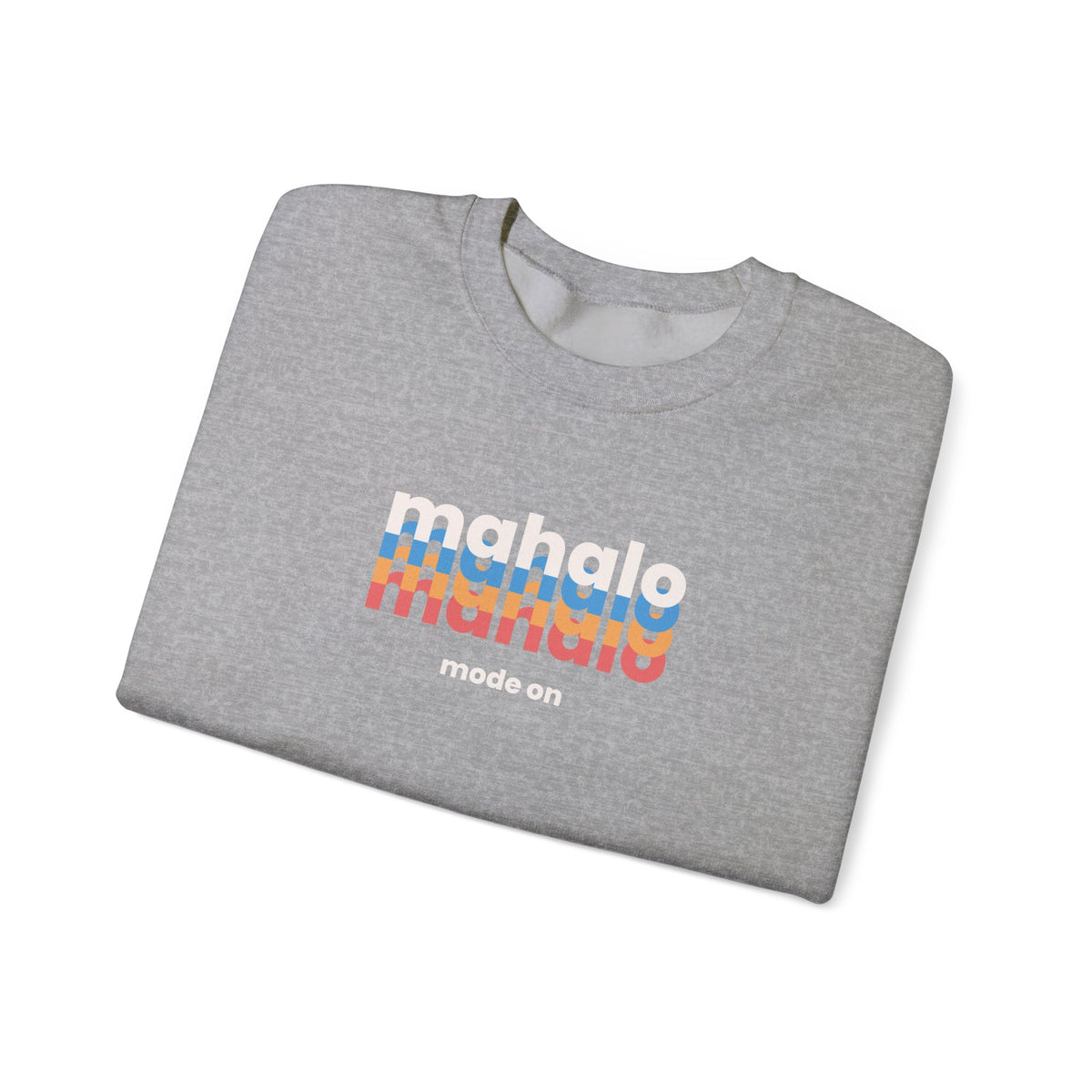 A folded heather gray crewneck sweatshirt featuring a retro-style graphic on the front with the word 'mahalo' repeated in white, blue, orange, and red, with 'mode on' printed below in white.