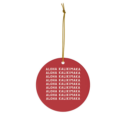 Red ceramic Christmas ornament featuring repeating cream Aloha Kalikimaka lettering on both sides.