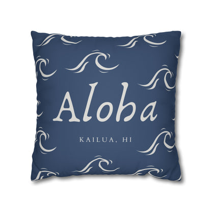 A square throw pillow in navy blue with white wave patterns and the text 'Aloha' and 'KAILUA, HI' printed on the front, shown against a plain white background.