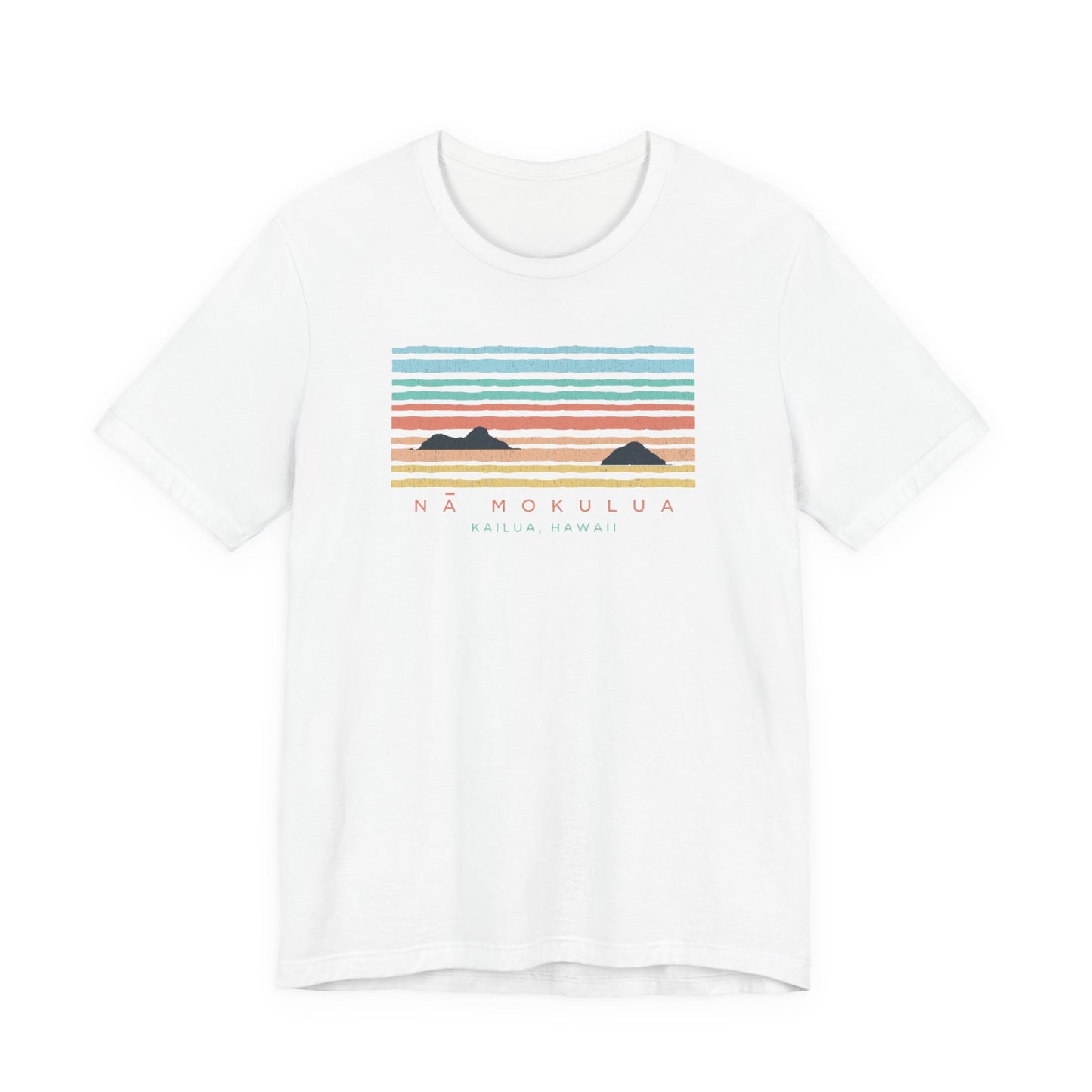 A white short-sleeve crewneck t-shirt featuring a colorful graphic print of a sunset over mountains with the text 'NÁ MOKULUA' and 'KAILUA, HAWAII' printed below.