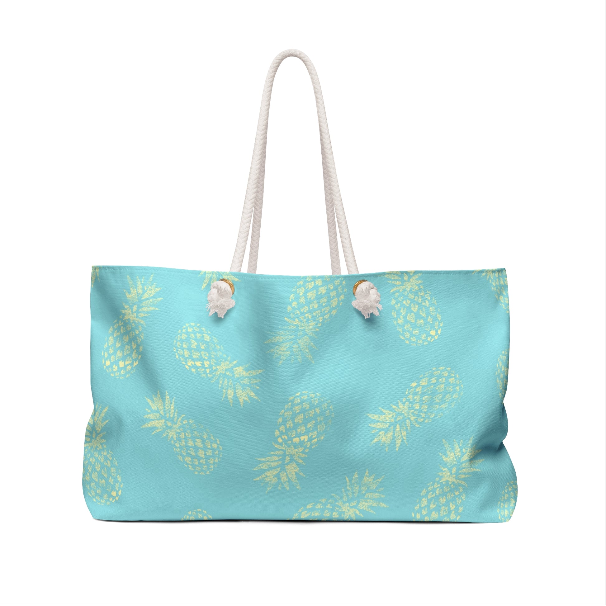 A light blue tote bag with a repeating yellow pineapple print and white rope handles, shown against a plain white background.