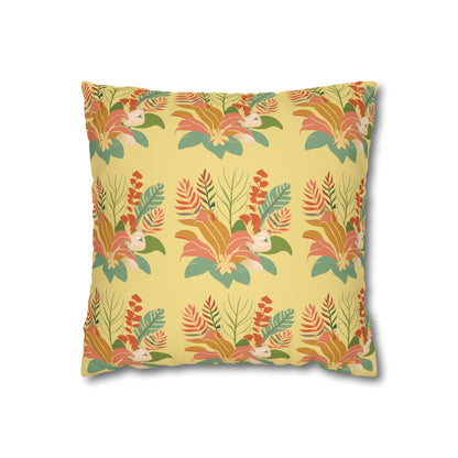 A square throw pillow featuring a retro-style botanical pattern with orange, green, and cream leaves on a pale yellow background, shown against a plain white studio backdrop.