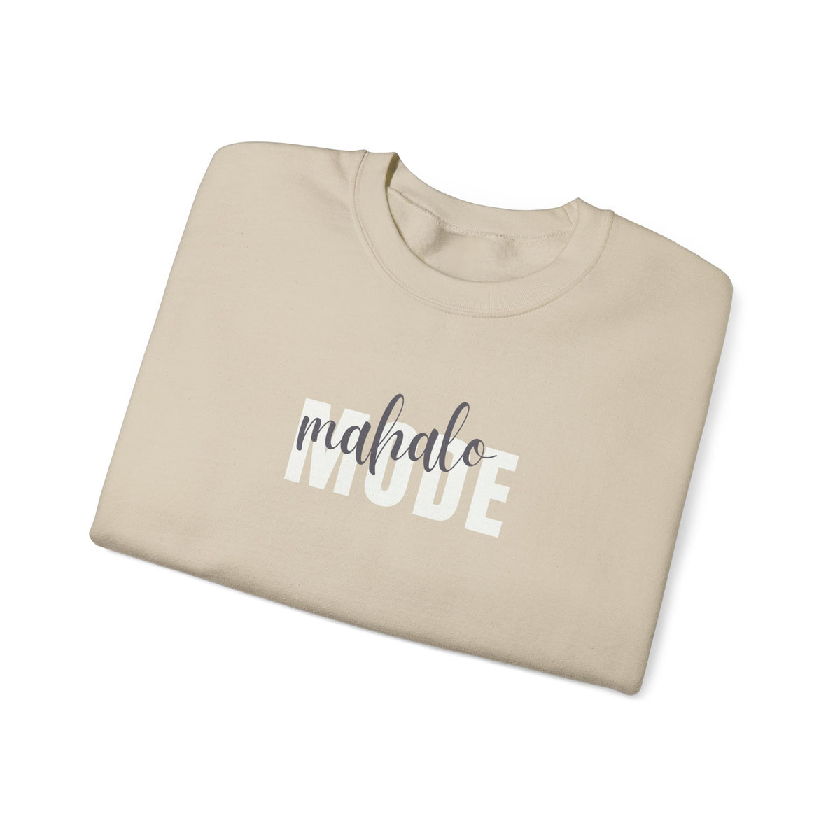 A beige crewneck t-shirt folded neatly, featuring the text 'mahalo MODE' printed on the front in white and dark gray, set against a clean white background.