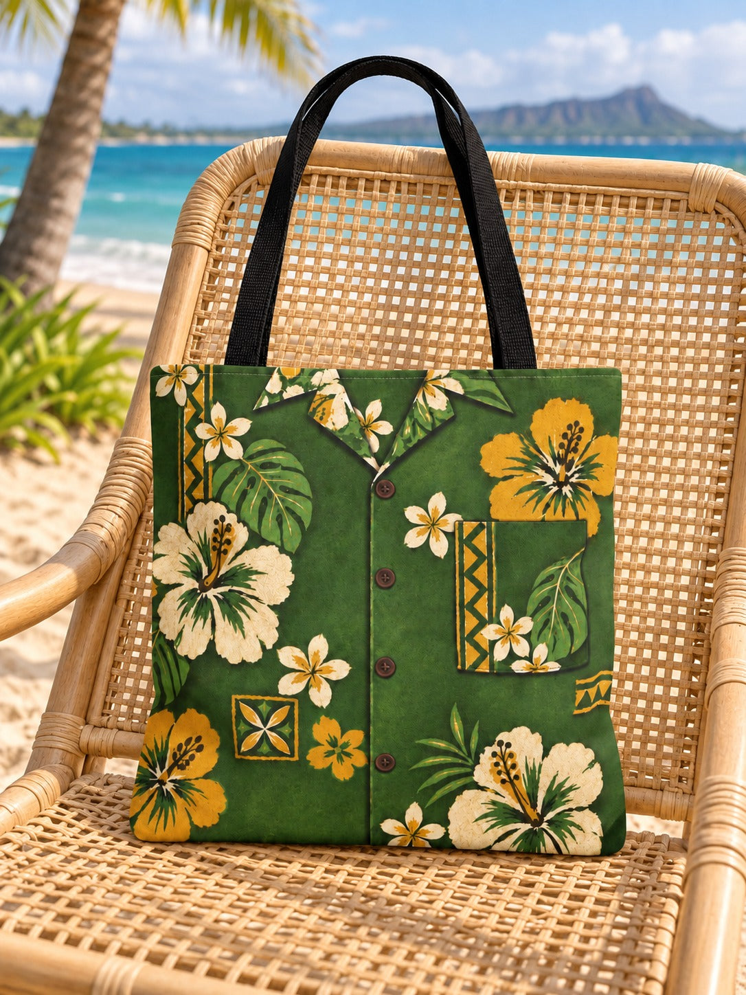 Green tote on rattan chair: Green vintage aloha shirt tote with cream and mustard hibiscus flowers displayed on a light rattan chair beside the beach.