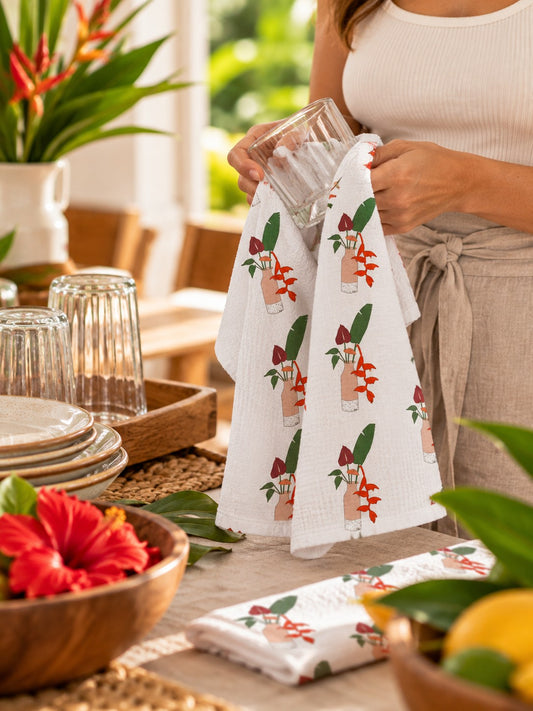 Tropical Floral Kitchen Towel — Woman drying a glass with a tropical floral kitchen towel in a warm island-inspired kitchen.