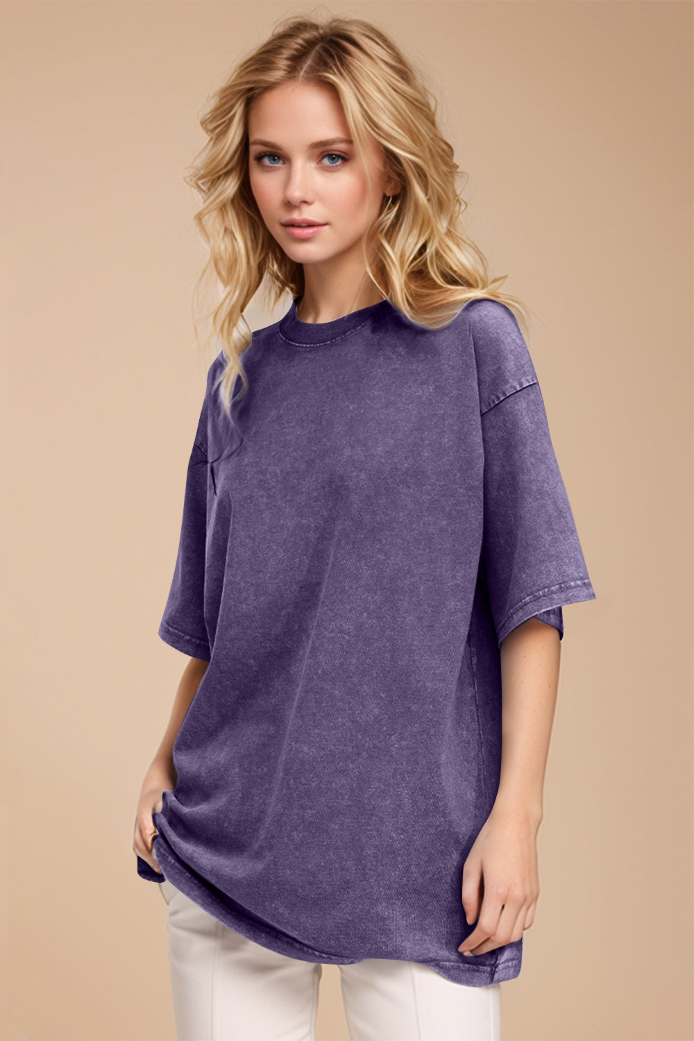Woman wearing a purple oversized t-shirt against a beige background