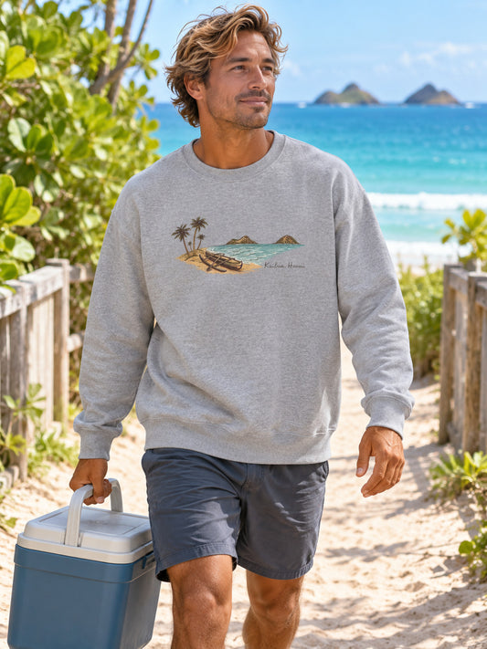 Surfer carrying a cooler to the beach in a grey Kailua canoe and Mokulua Islands sweatshirt.