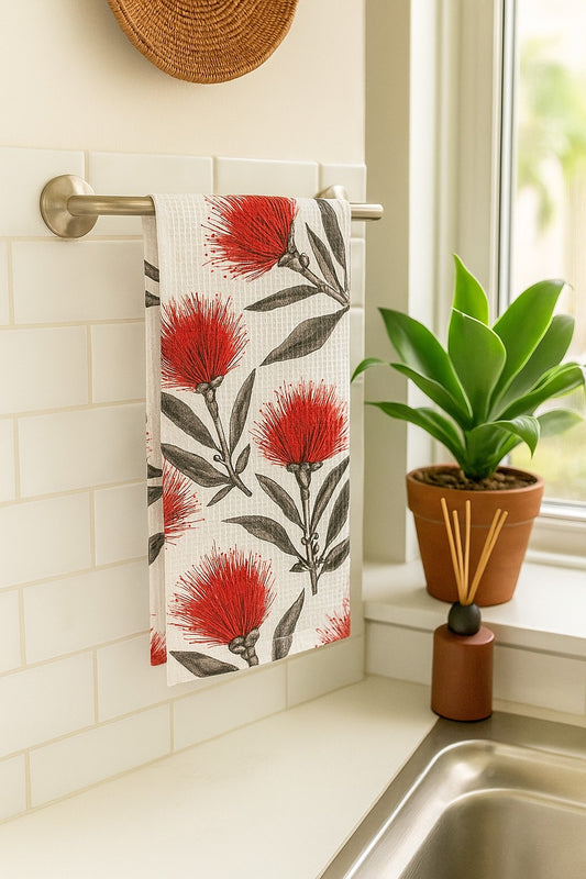 Red ʻŌhiʻa lehua kitchen towel hanging in a tropical bathroom