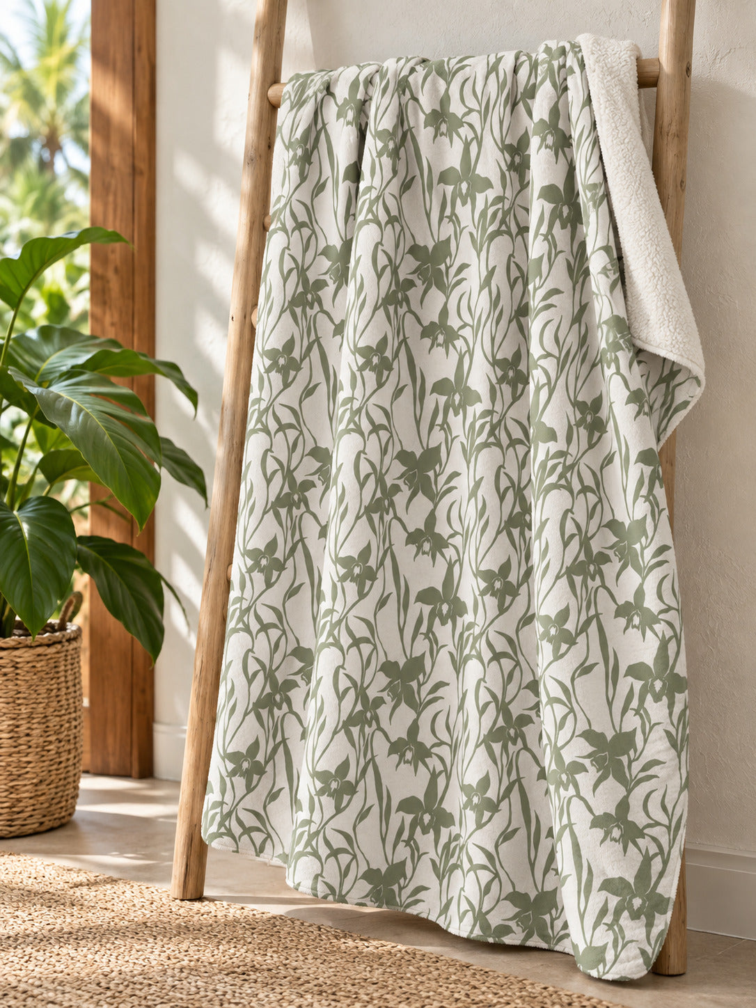 Orchid Sage sherpa fleece blanket displayed on a natural wood ladder in a bright tropical Hawaiʻi home.
