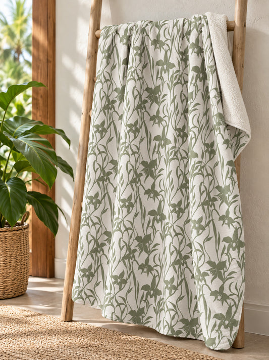Orchid Sage sherpa fleece blanket displayed on a natural wood ladder in a bright tropical Hawaiʻi home.